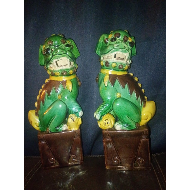 Add protection, charm, and vibrant traditional elegance to your space with this striking pair of vintage ceramic Foo Dogs...