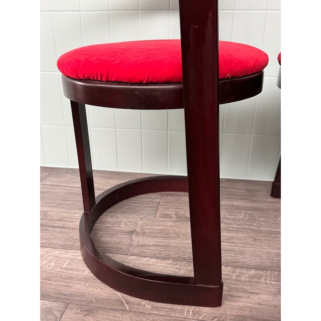 Pair of Italian-made chairs from the 1970s. The structure has a very original design in dark mahogany-stained beech. The...