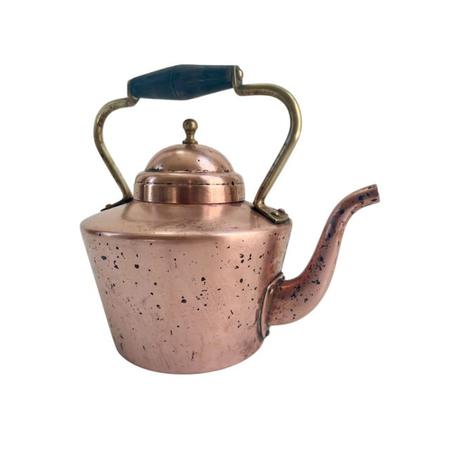 Desirable solid copper with brass handles and knobs tea pot with unique wooden handles. Designed for use on gas or...