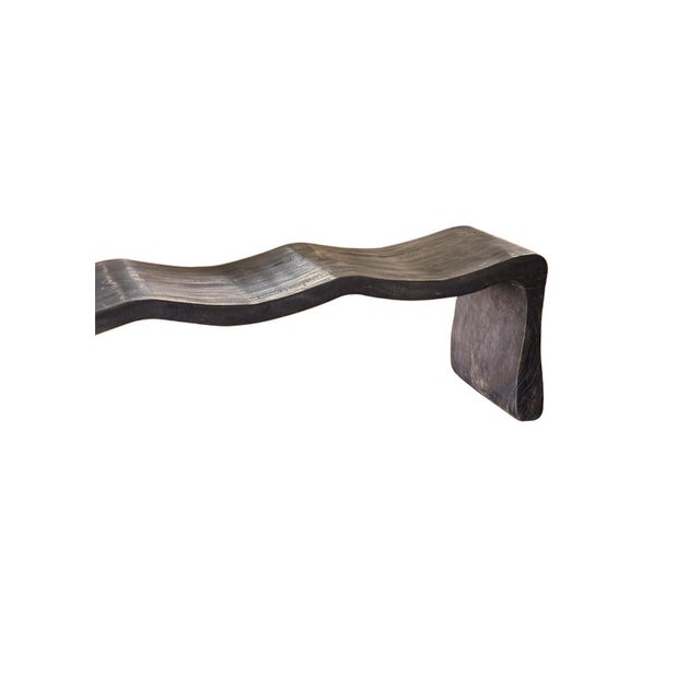Bold in scale and sculptural in form, this monumental bench is handcrafted from solid mango wood and finished in a rich...
