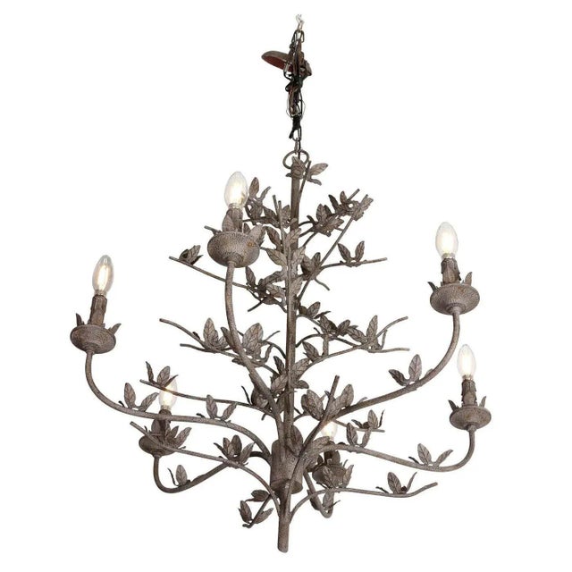 This Six-Arm hand-forged iron chandelier features a refined leaf motif that adds a touch of nature-inspired elegance. Its...