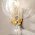 This Elegant Pair of Mid-Century Modernist Hand-Blown Murano Glass Striated Translucent Leaf Sconces are created by the...