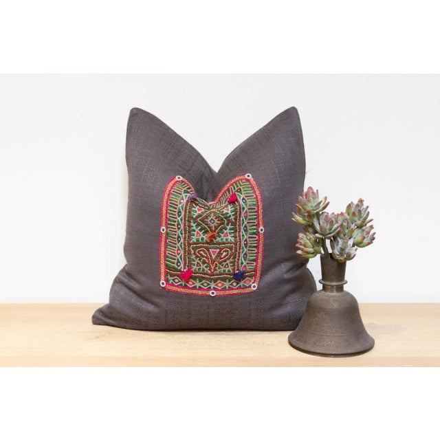 Crafted from fragments of exquisitely hand-embroidered tapestry adorned with intricate open-chain stitch embroidery, this...