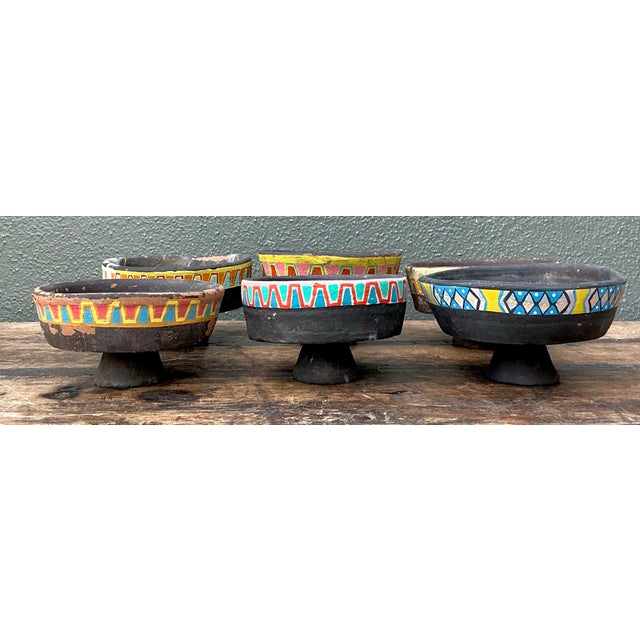 This set of six vintage pedestal bowls is a lively study in folk-art color against dark, earthy clay. Each bowl is a...