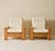 A pair of Scandinavian Modern lounge chairs crafted in solid pine and newly upholstered in textured ivory bouclé. The...