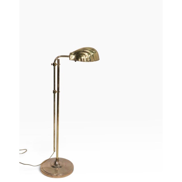 Adjustable brass pharmacy style floor lamp, with shell form shade. The lamp features a vertical center post allowing the...