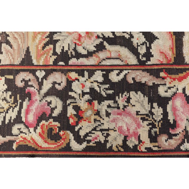 This exquisite antique Bessarabian rug, dating back to circa 1900, showcases the rich textile heritage of Eastern Europe...