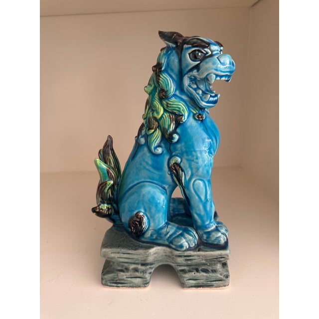 A handsome matched pair of mid-century Japanese guardian lions — komainu, also known as shishi or foo dogs — in a deep...