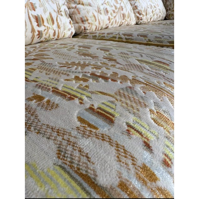 A traditional groovy mid century sofa with plush velvet floral and a slight kidney shape. This sofa was covered and...