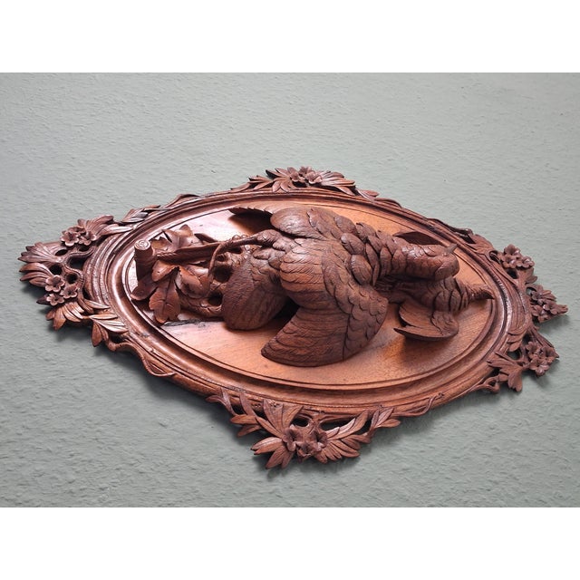 This hunting wall plaque is crafted entirely from walnut wood and masterfully carved, featuring two birds intricately...