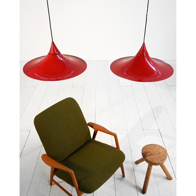 Pendant lamps in red lacquered metal with a large, flared shade and perforations at the top. Danish production, 1960s....