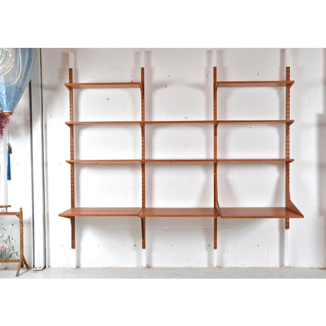 A lovely 1960s three-bay danish teak cado shelving system designed by paul cadovius consisting of 11 shelves, four...