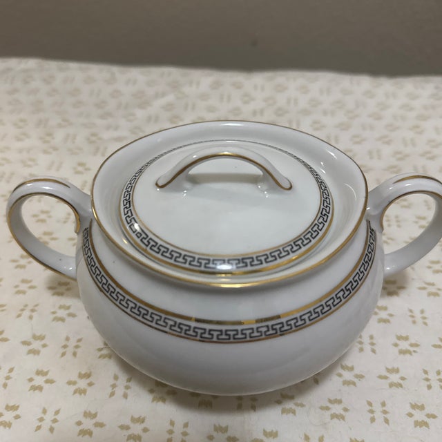 The bowl’s gently curved silhouette is complemented by a fitted lid, preserving contents while adding to its polished...