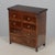 A 19th century French Country miniature chest hand-crafted of solid walnut with eight small dovetailed drawers with brass...