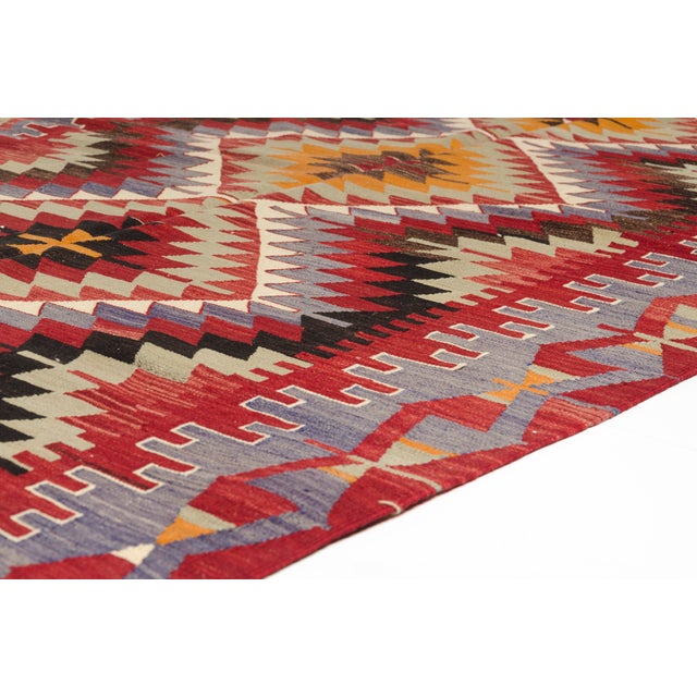 This is a vintage Turkish Oushak rug from the Mid 20th Century. The piece was hand-knotted.