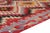 This is a vintage Turkish Oushak rug from the Mid 20th Century. The piece was hand-knotted.