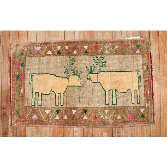Mid-20th Century Turkish rug depicting 2 deers on a brown field. Check the border out too! Measures: 1'9'' x 2'9''.