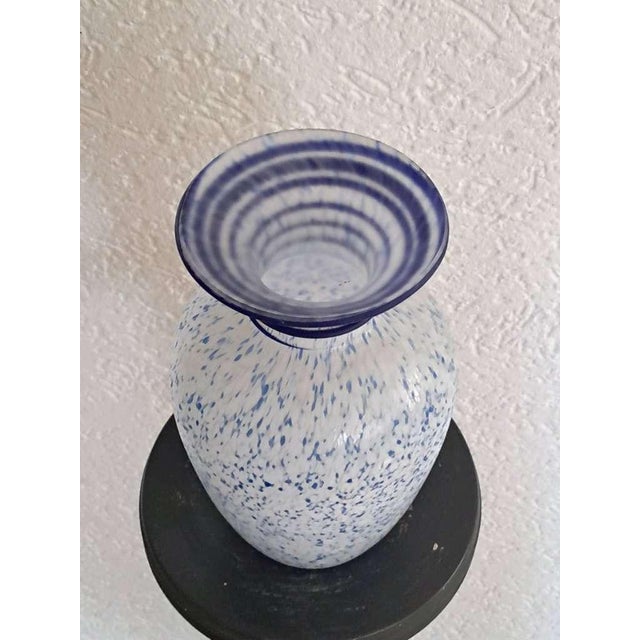 An elegant mid-20th century Murano art glass vase, handcrafted in Italy and distinguished by its refined lattimo (milk-...