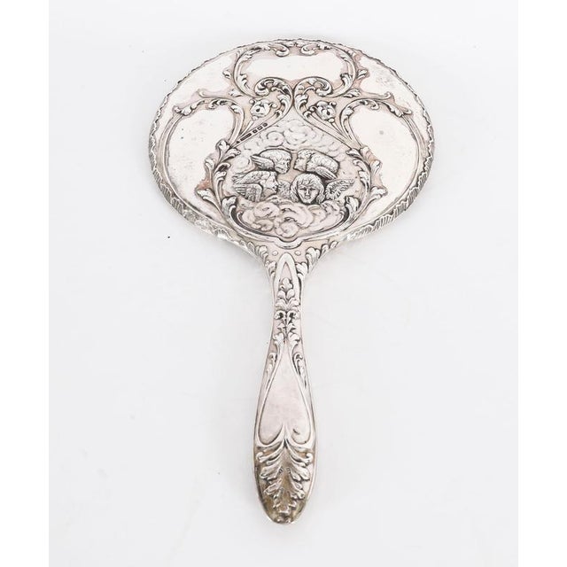 This is a stunning English antique sterling silver hand mirror with hallmarks for Birmingham 1912 and the makers mark of...