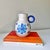 Vintage mid-century modern Bitossi pottery blue floral pitcher. The piece is hand painted with floral and starburst design.