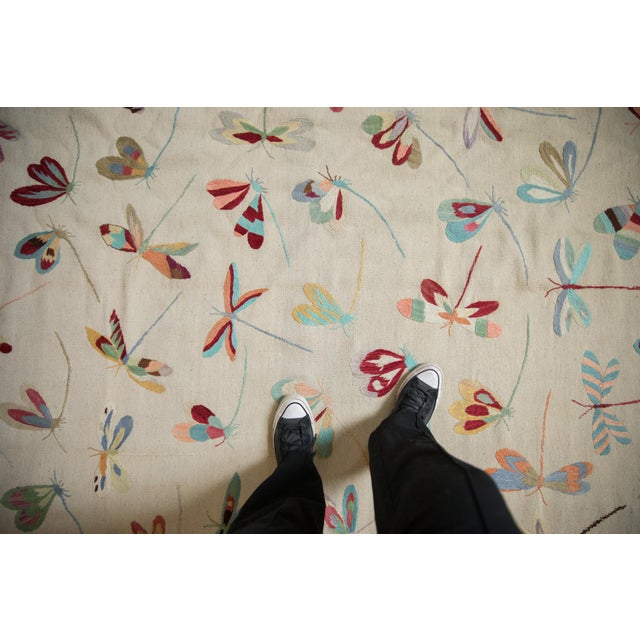 :: Plain woven Kilim with covered array, replete in coloration, of dragonflies in random views. Colors and shades include:...