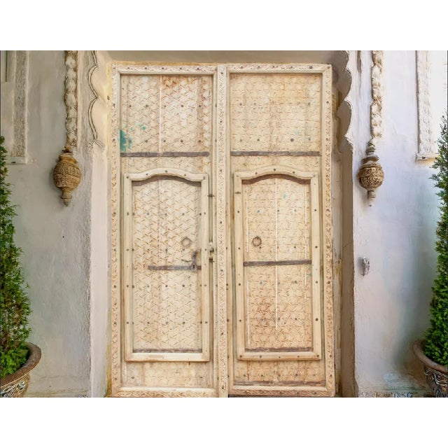 Once a fortress door in Rajasthan, India, this beautiful pair of antique carved doors are made from solid teak wood which...