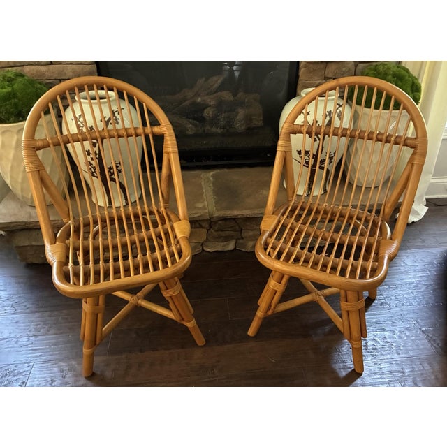 Pair of vintage Albini-style Italian bent rattan dining or occasional chairs featuring curved spindle backs, wrapped...