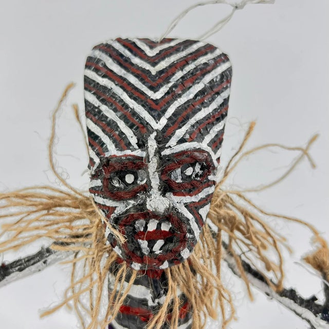 Makishi Dolls, originating in Zimbabwe and Zambia, are created on wire, painted with bold colors, and adorned with fabrics...