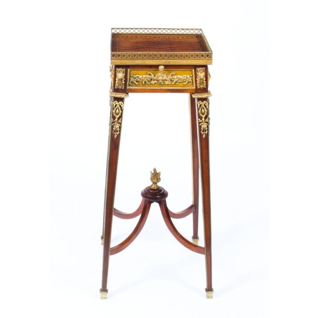 This is a fine antique french ormolu mounted mahogany and specimen wood parquetry stand firmly attributed to françois...