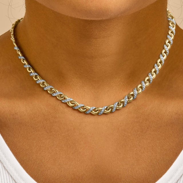 Create your style statement with this dazzling pendant. Chiseled to perfection, this interlock pendant is composed of 10...