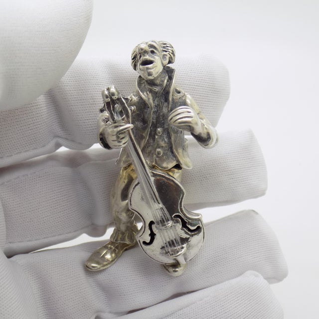 This vintage silver musician figurine depicts a clown performing with a contrabass, crafted as a desktop accent, shelf...