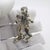 This vintage silver musician figurine depicts a clown performing with a contrabass, crafted as a desktop accent, shelf...