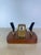 Charming vintage desk accessory combining a mechanical flip calendar with dual pen holders, mounted on a solid walnut...