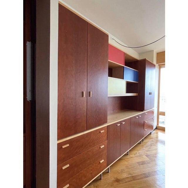 Designed by R&D Poliform Authentic Italian modular day/wall system in warm reddish-brown wood with light wood edges and...