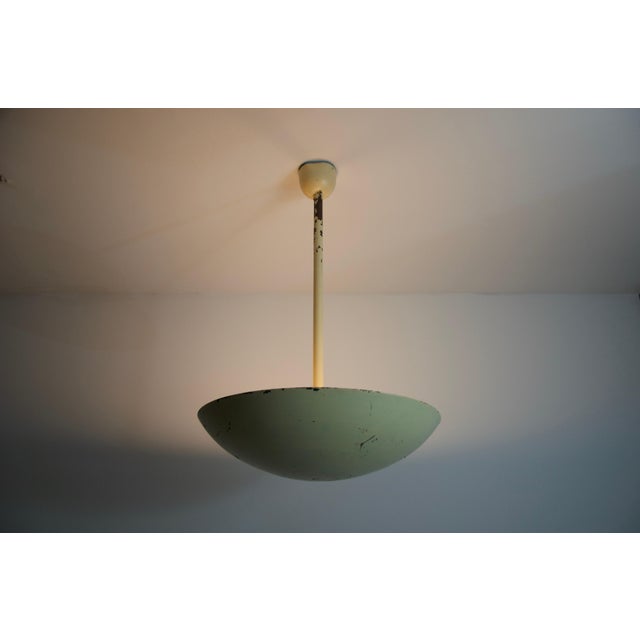 This 1960s metal ceiling lamp from Germany embodies the understated elegance of mid-century design. Featuring a clean,...