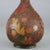 An antique Chinese Aesthetic Cloisonne bud vase offers enameled metal construction all-over textured wood bark design with...