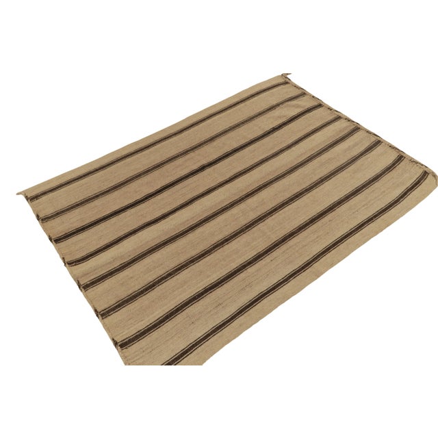 Connoting mid-century Turkish panel-weaving styles circa 1950-1960, a 5x7 vintage kilim rug from our flatweave curations....