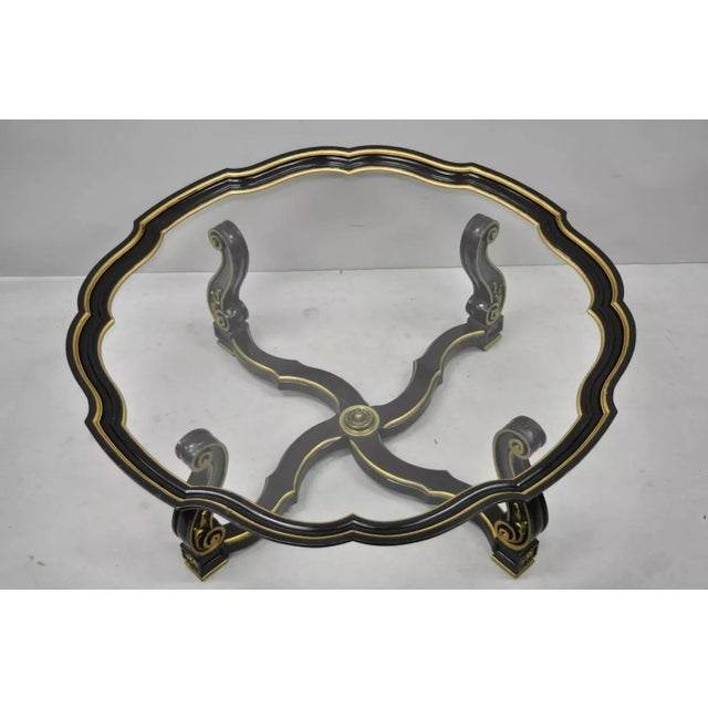 Vintage Italian Hollywood Regency Style Black and Gold Glass Top Coffee Table with Scalloped Edge. Item features a black...