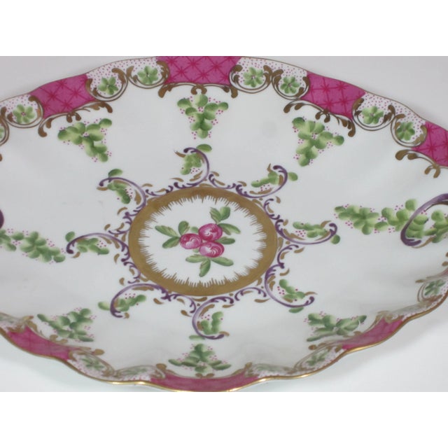 Lovely Handpainted oval dish with scalloped edge. Decorated with deep rose, green and gold accents.