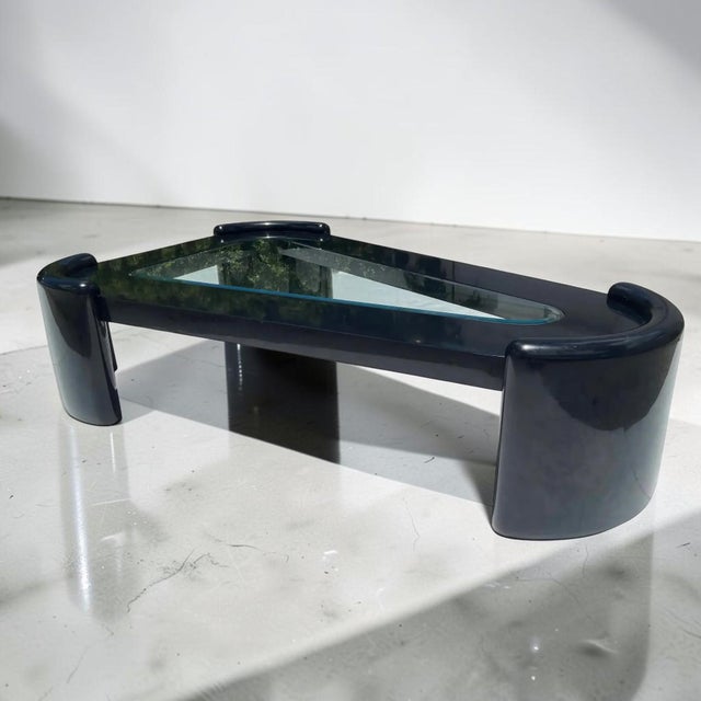 Massive postmodern black lacquer coffee table with triangular beveled glass insert. This monumental piece has the shape...