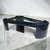 Massive postmodern black lacquer coffee table with triangular beveled glass insert. This monumental piece has the shape...