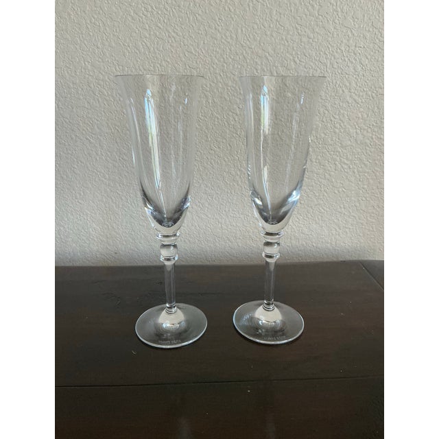 Elegant pair of authentic Ralph Lauren crystal champagne flutes featuring a sophisticated smoke-gray tint with clear...
