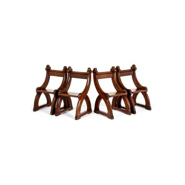 A sturdy set of four pitch pine gothic revival victorian altar chairs. The chairs exhibit a moulded top rail back rest...
