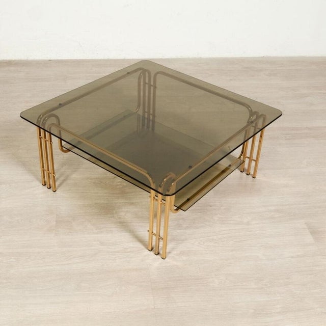 Beautiful and elegant original vintage coffee table, skeleton in gold-colored metal, with harmonious workmanship, smoked...