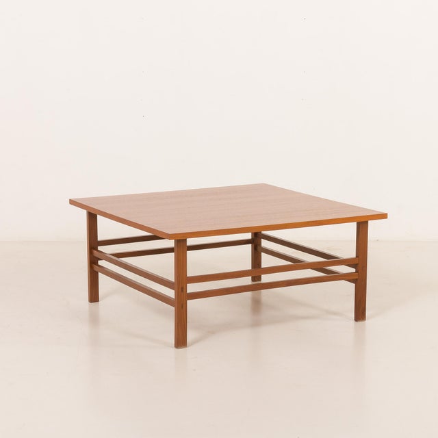 This elegant scandinavian mid-century square teak coffee table was made in denmark some time in the 1970s and is a refined...