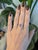 A 1.78-carat emerald-cut bi-color tourmaline blends soft pink and purple in a single natural stone at the centre of this...