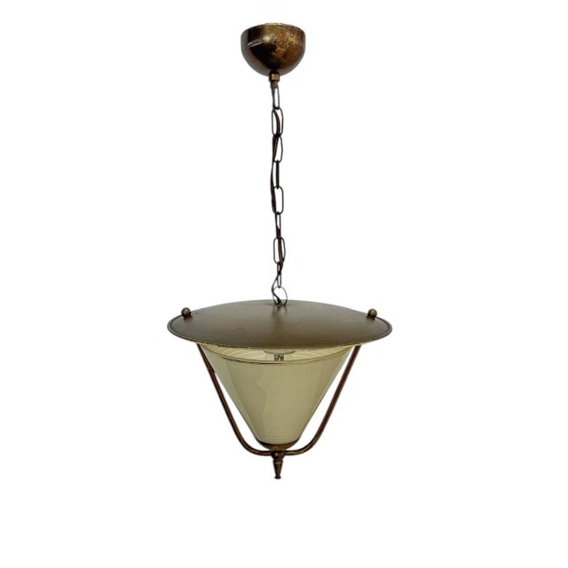 Pendant lamp from the 1950s, origin Netherlands. Materials: glass, metal, and brass. Works perfectly. Condition: glass OK...