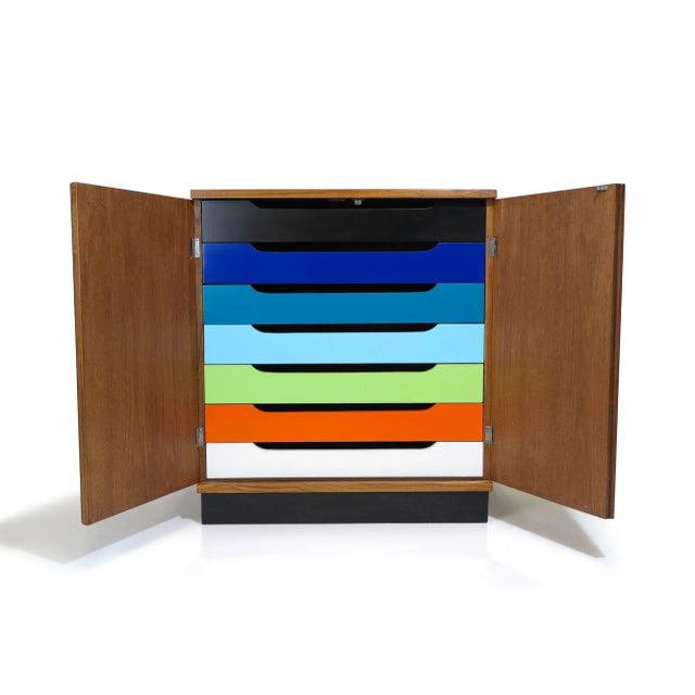 Mid century teak cabinet in manner of Hans Olsen with series of interior gradient colored drawers. Measurements W 32" x D...