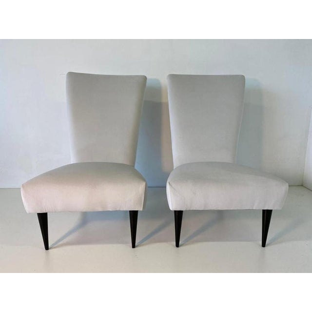 Charming Italian Art Deco bedroom armchairs from the 1940s, defined by their soft and enveloping silhouette that blends...
