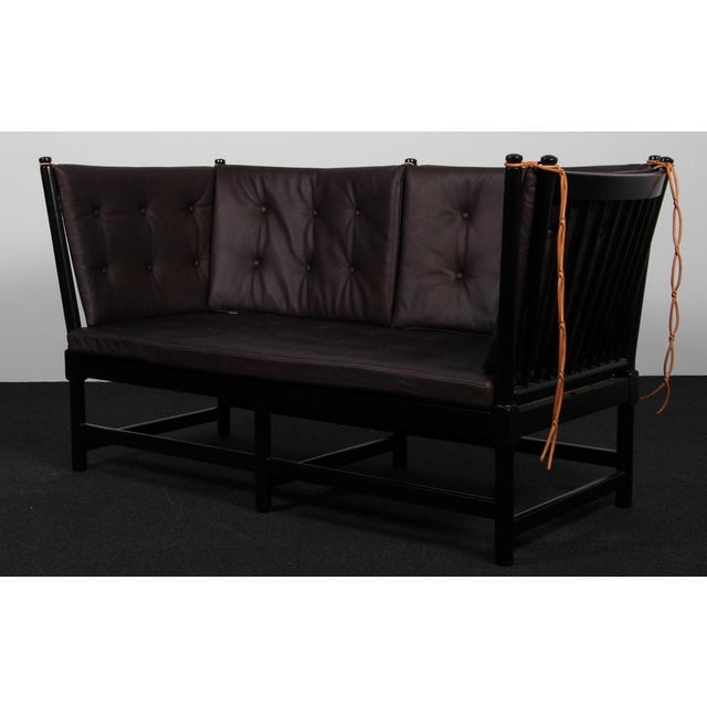 Børge Mogensen two-seat sofa in black lacquered beech and new upholstered cushions of mokka full grain aniline leather....